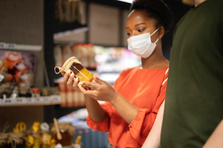 man-woman-shopping-grocery-store-while-wearing-medical-masks